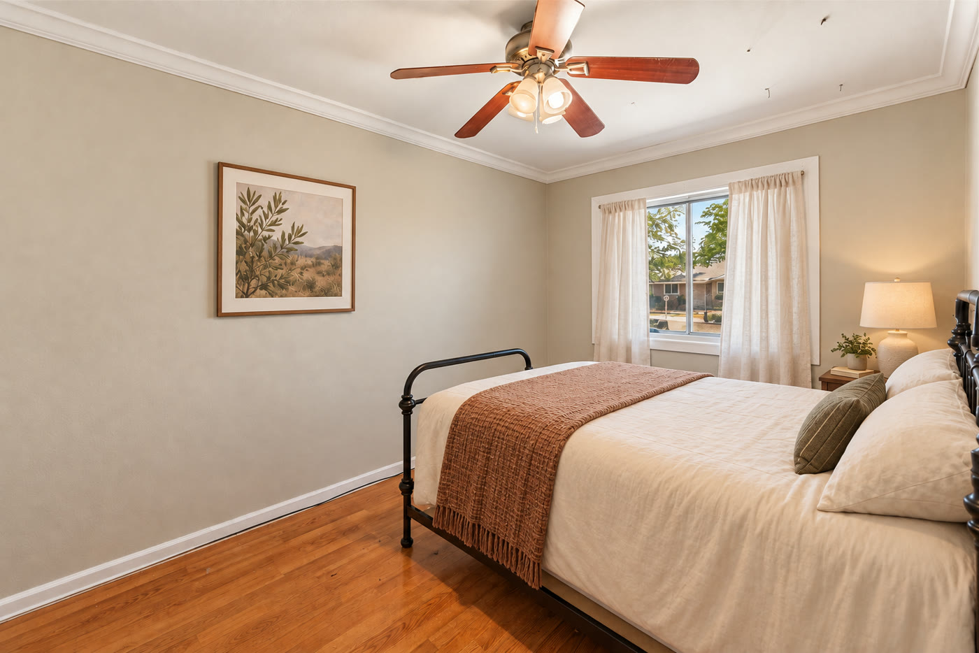 Virtually staged bedroom with metal bed and layered bedding